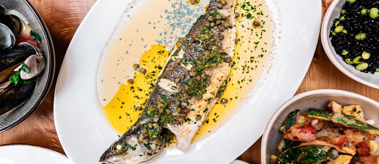 Whole fish with sides, a signature dish at The Shuckery